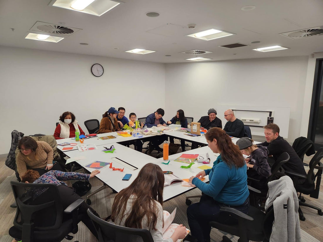 a group of people folding with paper